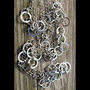 3 graduating strands of cascading silver circles